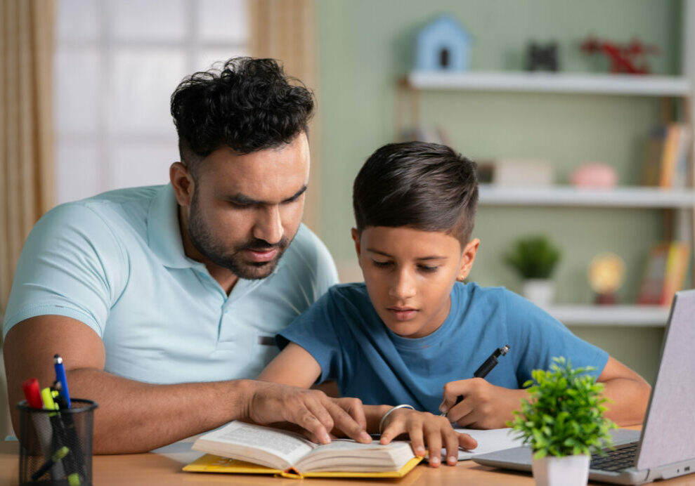 Indian father helping son with homework