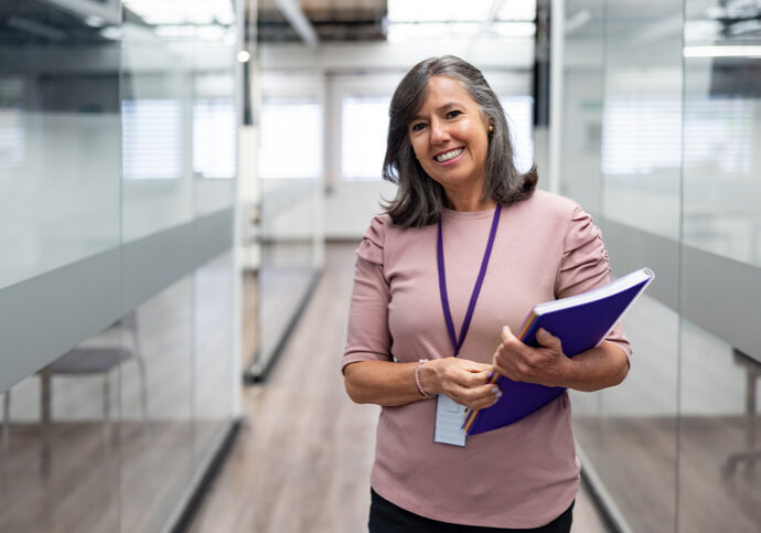 Portrait of a happy teacher smiling at the university