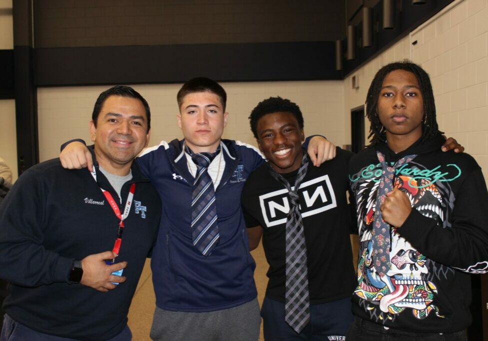 Dr. Angello Villarreal with students at the Empowering Young Black Males Summit hosted by Monmouth University.
